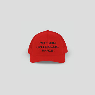 Red cap with 'MAISON ANTONIUS PARIS' text on a light gray background